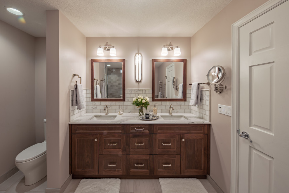 Large transitional master bathroom in Minneapolis with recessed-panel cabinets, medium wood cabinets, beige walls, an undermount sink, a hinged shower door, beige benchtops, an enclosed toilet, a double vanity and a built-in vanity.