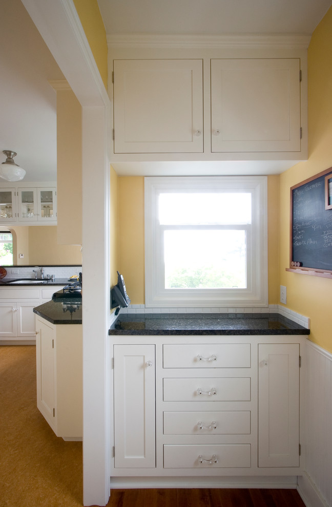 Example of a small transitional u-shaped linoleum floor eat-in kitchen design in Seattle with an undermount sink, shaker cabinets, white cabinets, granite countertops, white backsplash, subway tile backsplash, stainless steel appliances and a peninsula