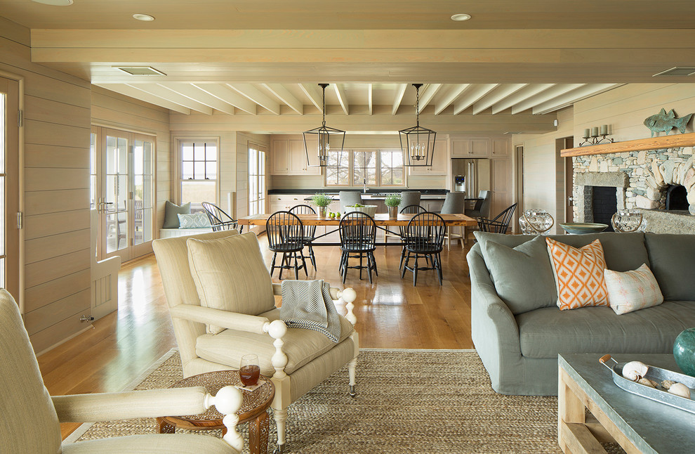 Beach style open concept medium tone wood floor living room photo in Boston with a standard fireplace and a stone fireplace