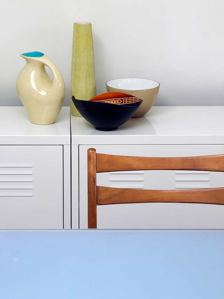 This is an example of a modern kitchen in London with white cabinets.