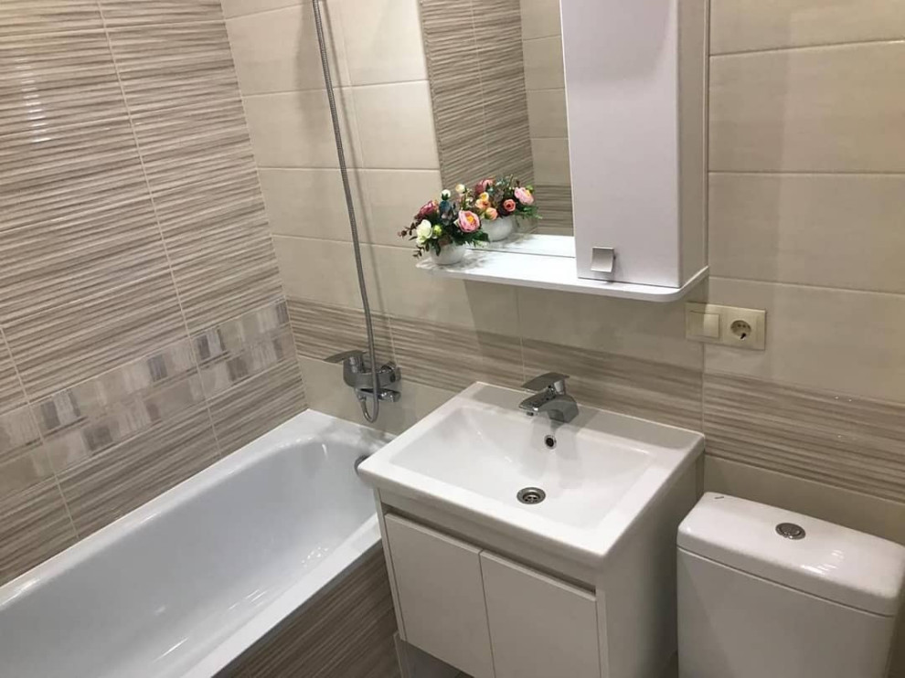 This is an example of a small contemporary master bathroom in Moscow with flat-panel cabinets, white cabinets, an alcove tub, a one-piece toilet, multi-coloured tile, ceramic tile, multi-coloured walls, ceramic floors, solid surface benchtops, white benchtops, a single vanity and a floating vanity.