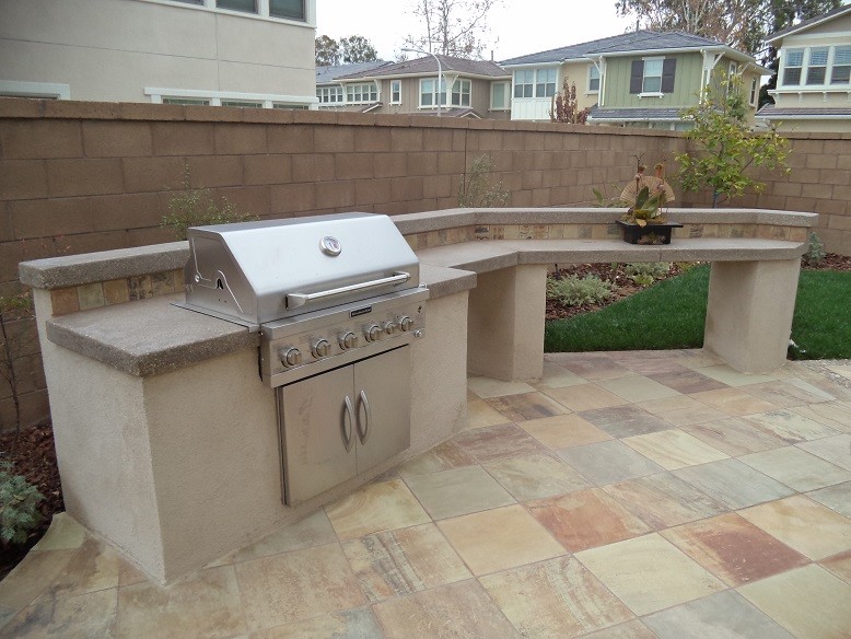 Design ideas for a transitional backyard patio in Orange County with an outdoor kitchen and tile.