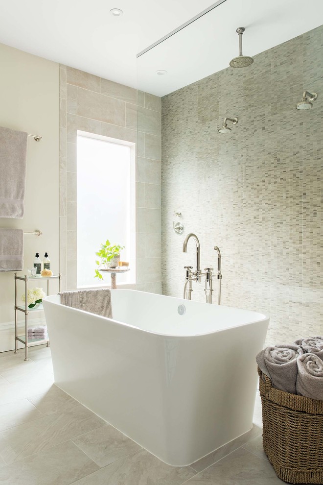 This is an example of a mid-sized transitional master bathroom in Boston with a freestanding tub, a double shower, gray tile, grey walls and grey floor.