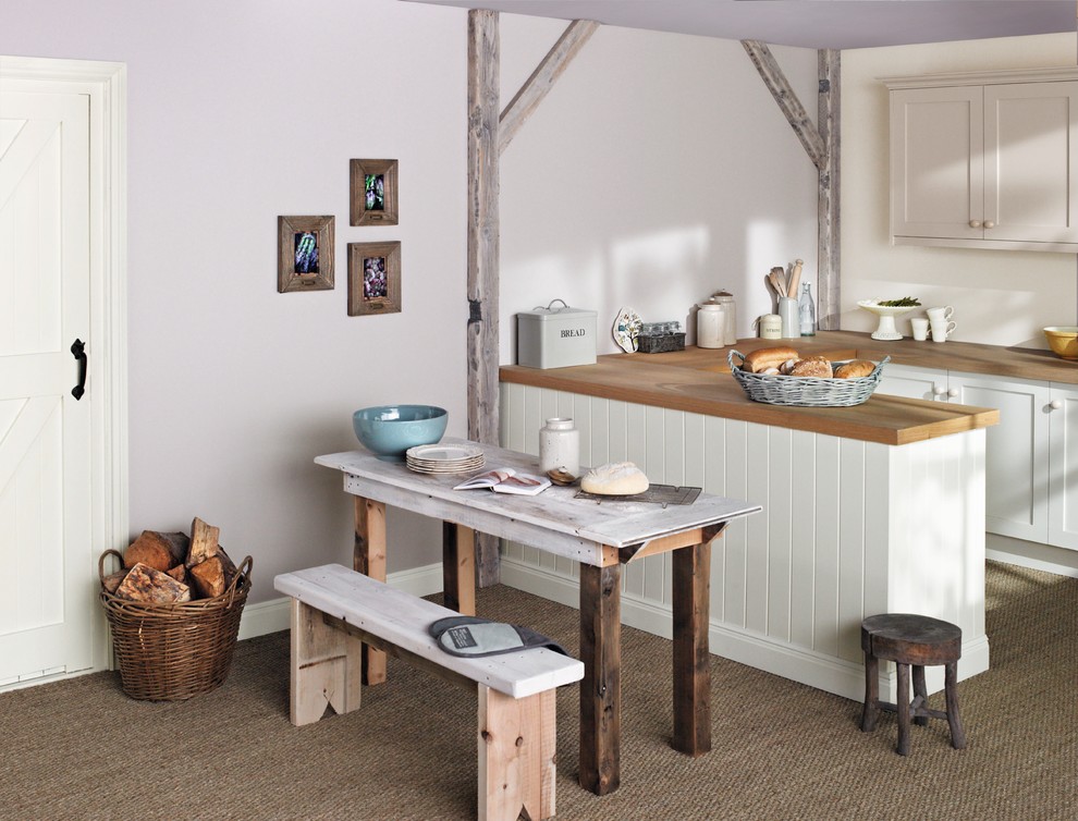Inspiration for a large scandinavian eat-in kitchen in Dublin with wood benchtops.