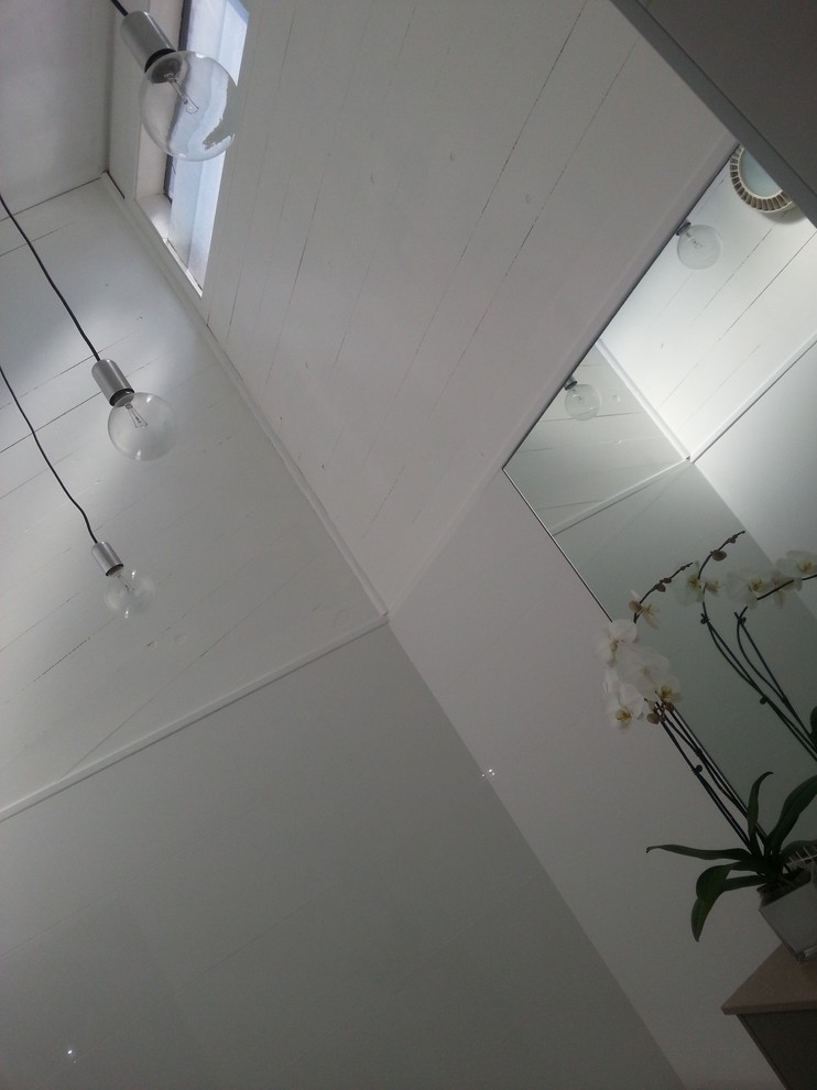 Mid-sized contemporary master bathroom in Sydney with flat-panel cabinets, green cabinets, a drop-in tub, an open shower, a wall-mount toilet, green tile, ceramic tile, white walls, ceramic floors, an integrated sink and engineered quartz benchtops.