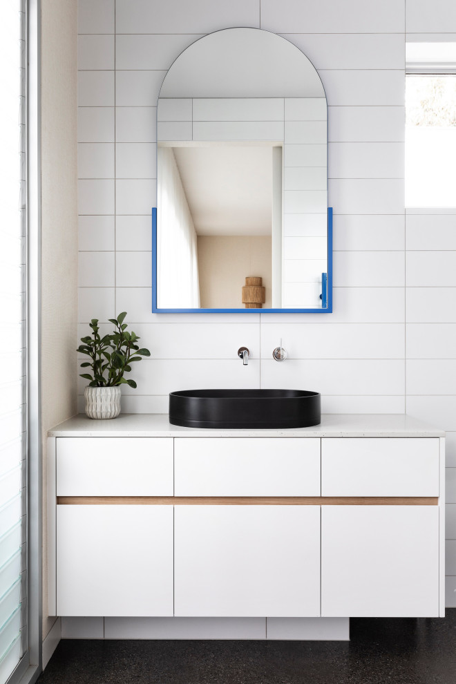Design ideas for a mid-sized contemporary 3/4 bathroom in Melbourne with flat-panel cabinets, white cabinets, a double shower, a one-piece toilet, white tile, porcelain tile, white walls, concrete floors, a vessel sink, engineered quartz benchtops, black floor, a sliding shower screen, white benchtops, a single vanity and a built-in vanity.