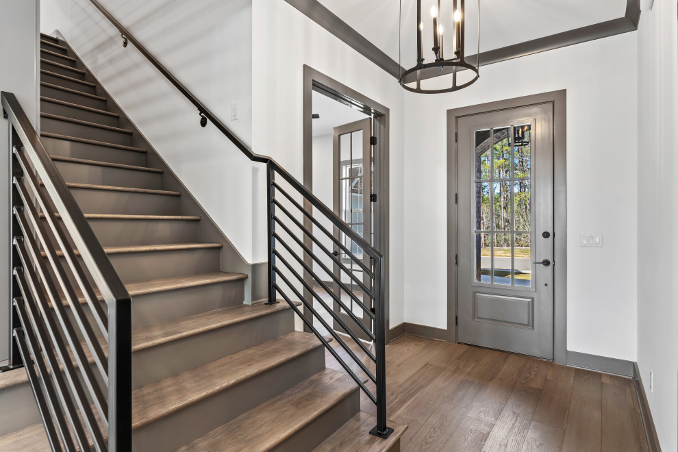 Example of a mid-sized transitional dark wood floor and brown floor foyer design with a gray front door