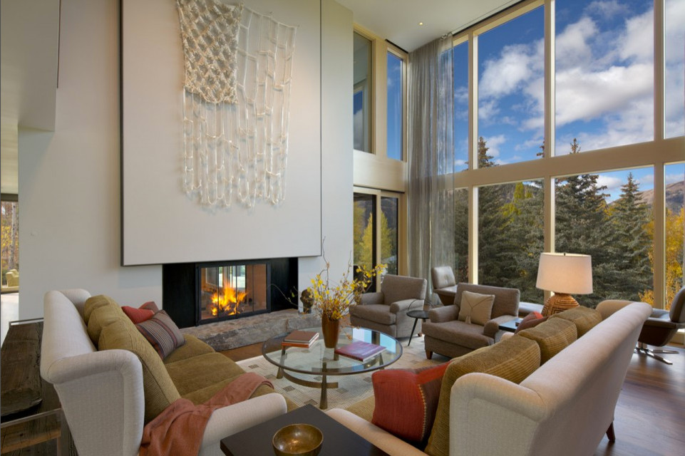 Photo of a mid-sized contemporary formal open concept living room in Other with white walls, medium hardwood floors, a two-sided fireplace, a metal fireplace surround and no tv.