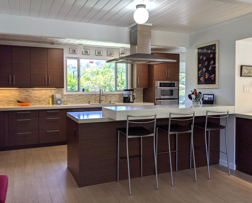 Photo of a mid-sized midcentury galley kitchen in San Francisco with dark wood cabinets, quartz benchtops, brown splashback, matchstick tile splashback, stainless steel appliances, porcelain floors and white benchtop.