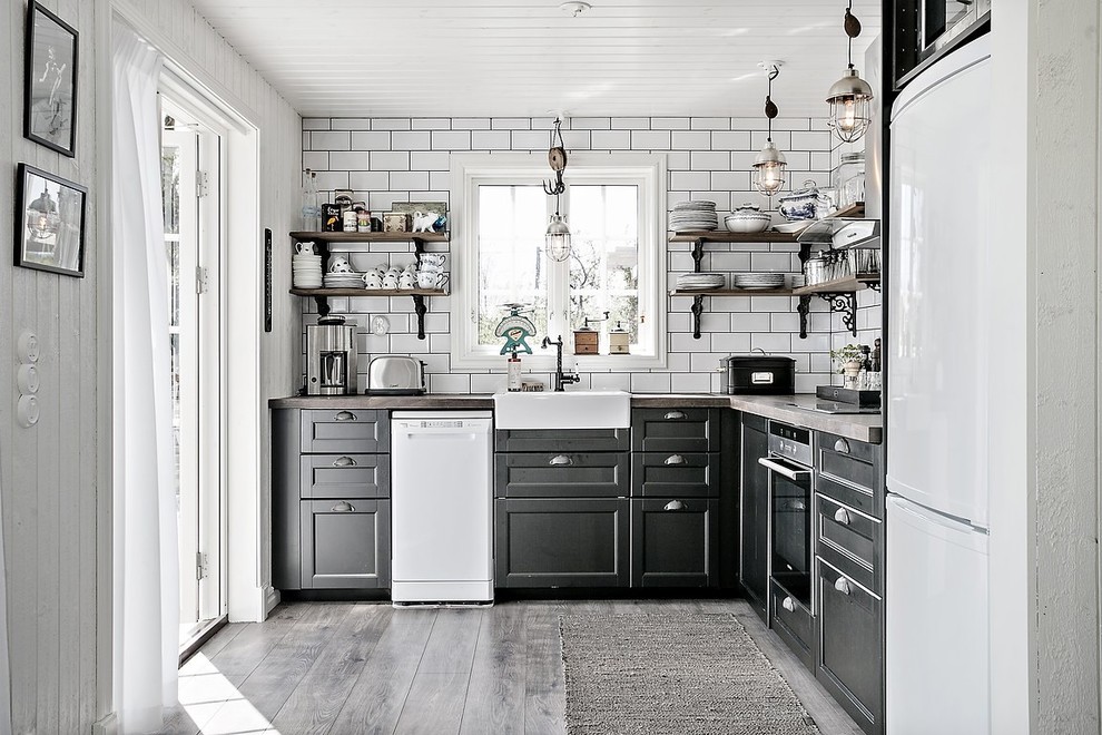 This is an example of a country l-shaped separate kitchen in Gothenburg with a single-bowl sink, open cabinets, black cabinets, white appliances and no island.