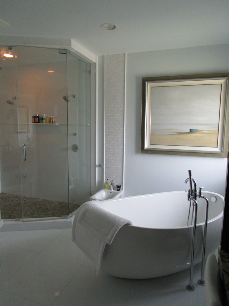 This is an example of a mid-sized eclectic master bathroom in Miami with furniture-like cabinets, dark wood cabinets, a freestanding tub, a corner shower, a one-piece toilet, white tile, ceramic tile, white walls, marble floors, an undermount sink, marble benchtops, white floor, a hinged shower door and multi-coloured benchtops.