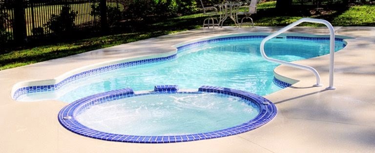 Large backyard concrete and custom-shaped natural hot tub photo in Denver