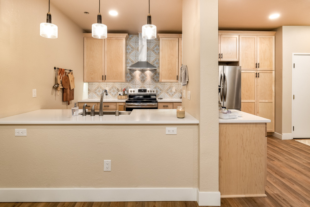 Inspiration for a small transitional galley eat-in kitchen remodel with shaker cabinets, light wood cabinets, quartz countertops, cement tile backsplash, stainless steel appliances, no island and white countertops