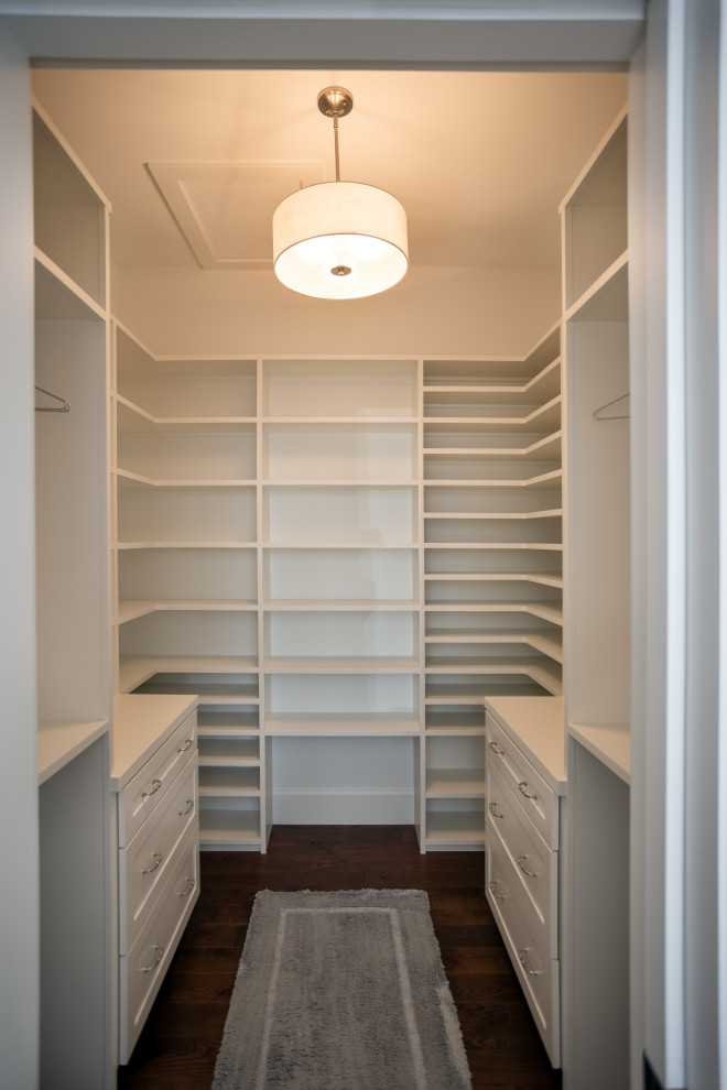 This is an example of a medium sized classic walk-in wardrobe in Other with shaker cabinets, white cabinets, dark hardwood flooring and brown floors.