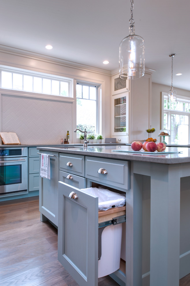 Inspiration for a beach style kitchen in Denver with flat-panel cabinets and blue cabinets.