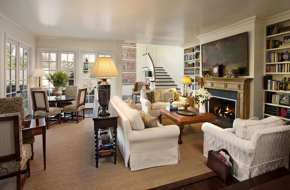 Design ideas for a traditional family room in Los Angeles with a library, beige walls, dark hardwood floors and a standard fireplace.