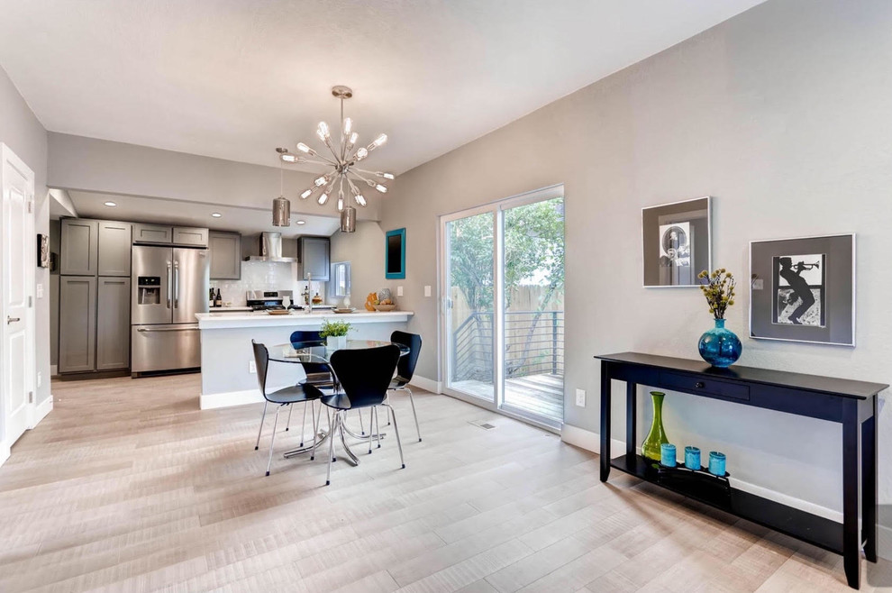Inspiration for a mid-sized transitional light wood floor enclosed dining room remodel with gray walls