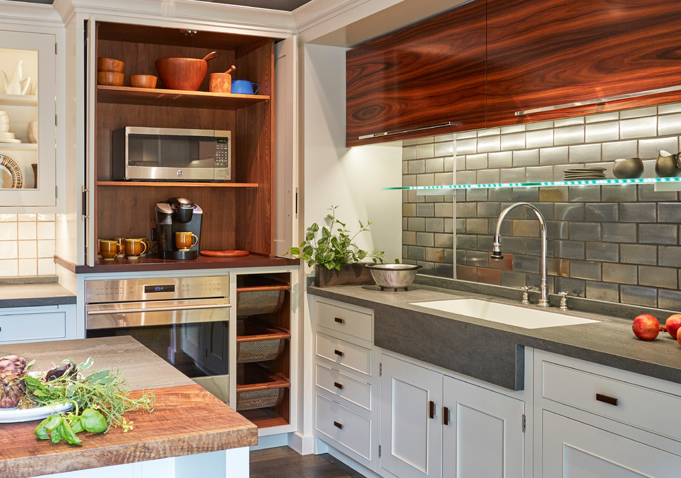 This is an example of a mid-sized transitional l-shaped separate kitchen in Chicago with flat-panel cabinets, quartz benchtops, porcelain splashback, with island, grey benchtop, an undermount sink, medium wood cabinets, metallic splashback, stainless steel appliances, dark hardwood floors and brown floor.