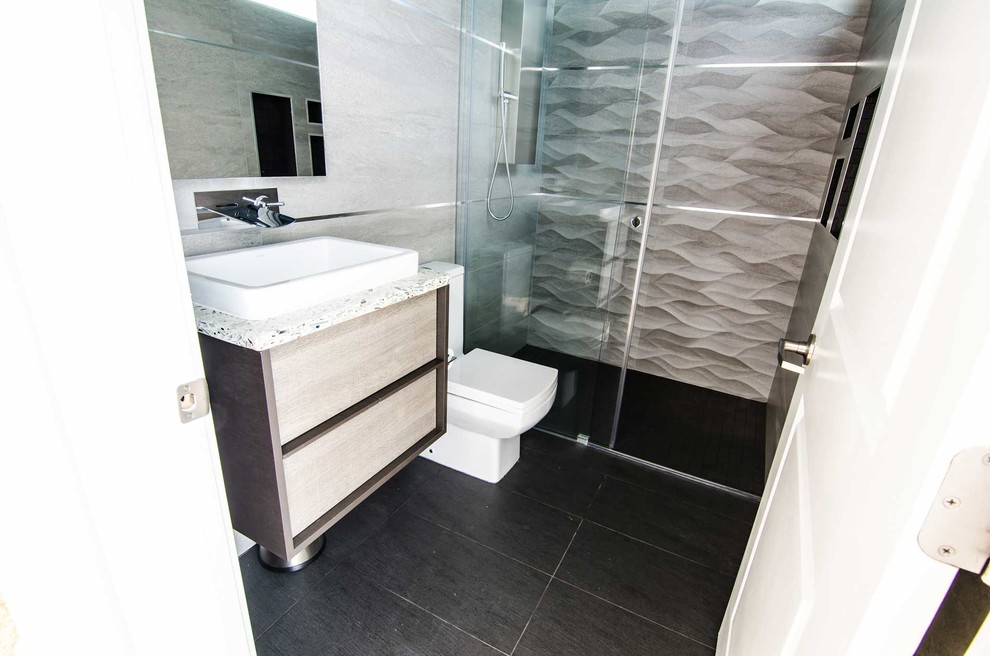 This is an example of a modern bathroom in DC Metro with recycled glass benchtops.