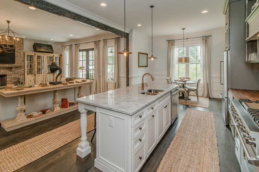 Design ideas for a transitional galley open plan kitchen in Nashville with a double-bowl sink, recessed-panel cabinets, white cabinets and stainless steel appliances.
