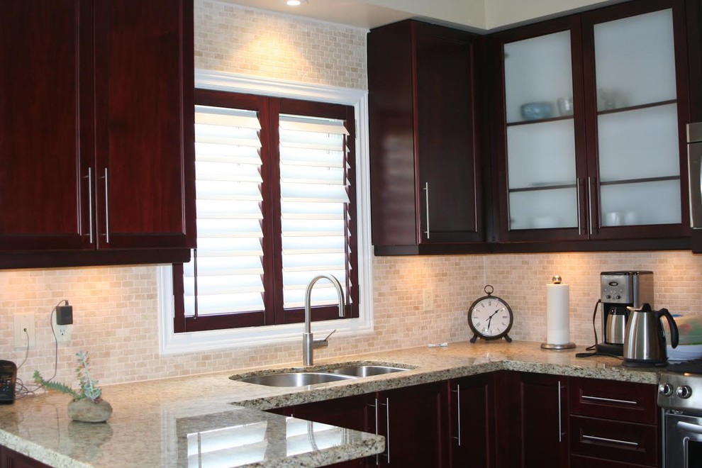 Photo of a traditional kitchen in Toronto with a double-bowl sink, shaker cabinets, medium wood cabinets, granite benchtops, beige splashback, mosaic tile splashback and stainless steel appliances.
