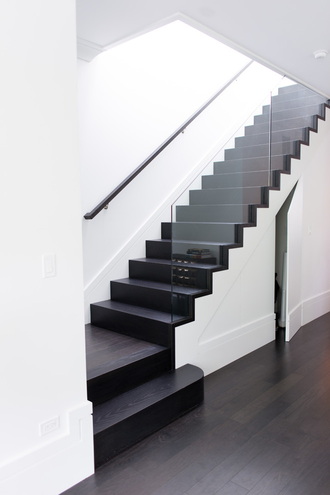 Mid-sized modern wood straight staircase in Chicago with wood risers and glass railing.