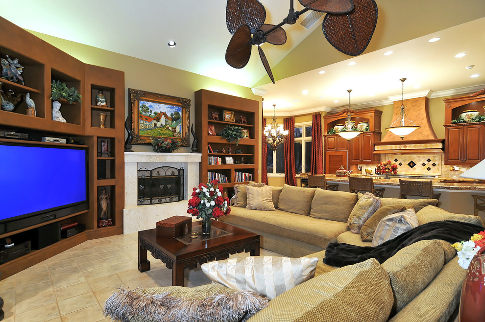 Tropical open concept family room in Tampa with beige walls and a corner tv.