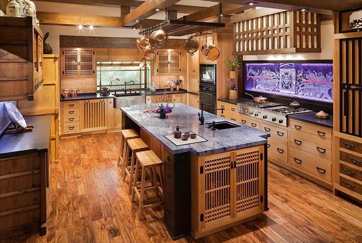 Inspiration for a large asian u-shaped kitchen in San Francisco with a farmhouse sink, flat-panel cabinets, light wood cabinets, wood benchtops, white splashback, subway tile splashback, stainless steel appliances, painted wood floors, with island and brown floor.