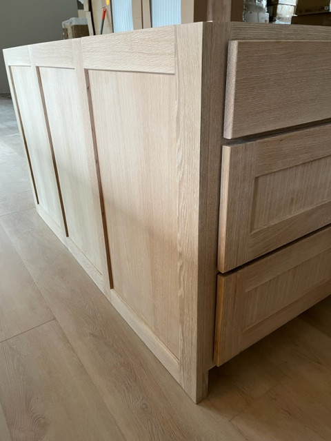 Example of a large kitchen design in Austin with shaker cabinets and an island