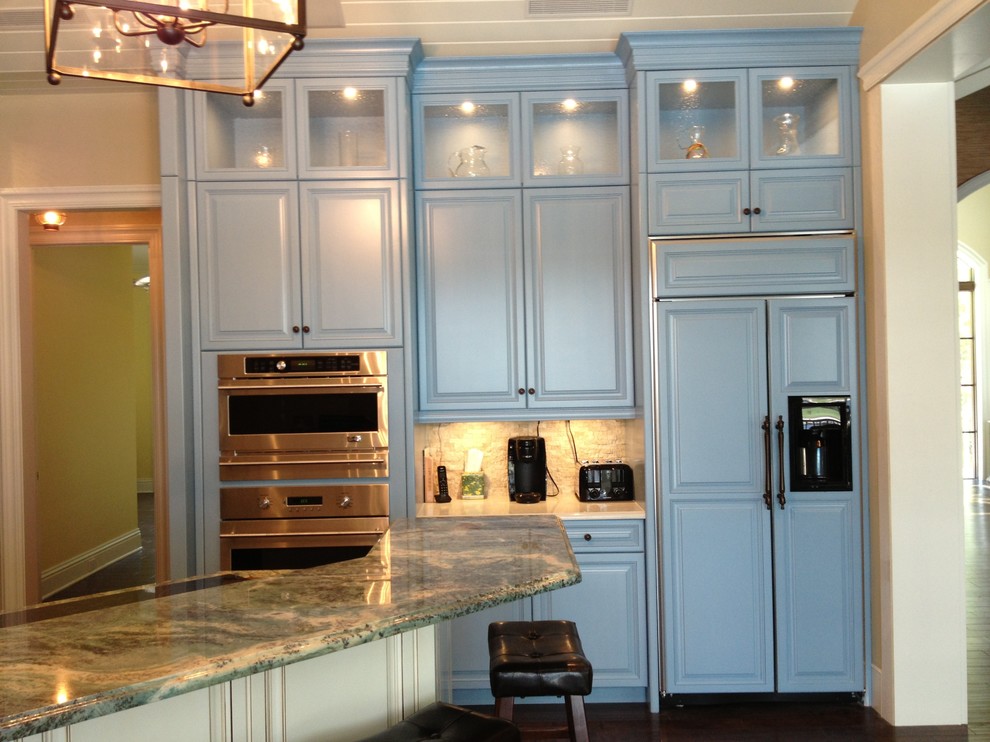 Example of a transitional eat-in kitchen design in Miami with raised-panel cabinets, blue cabinets and an island