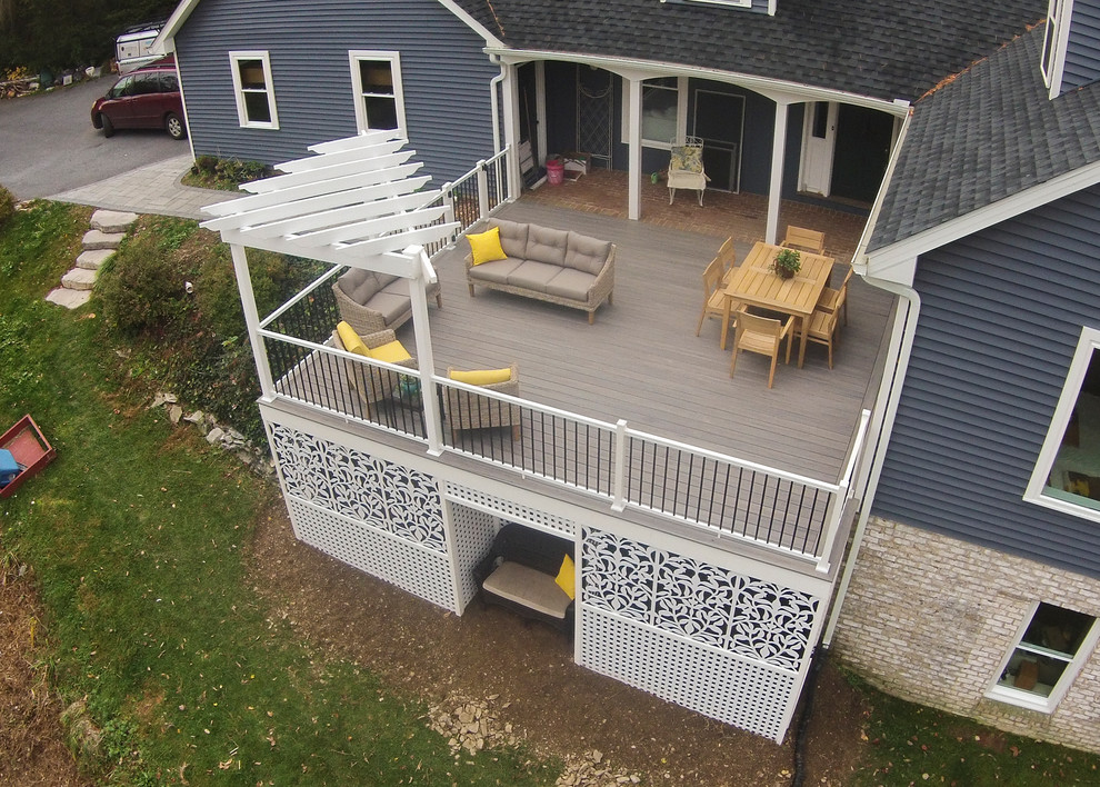 This is an example of a mid-sized modern side yard deck in Other with a pergola.