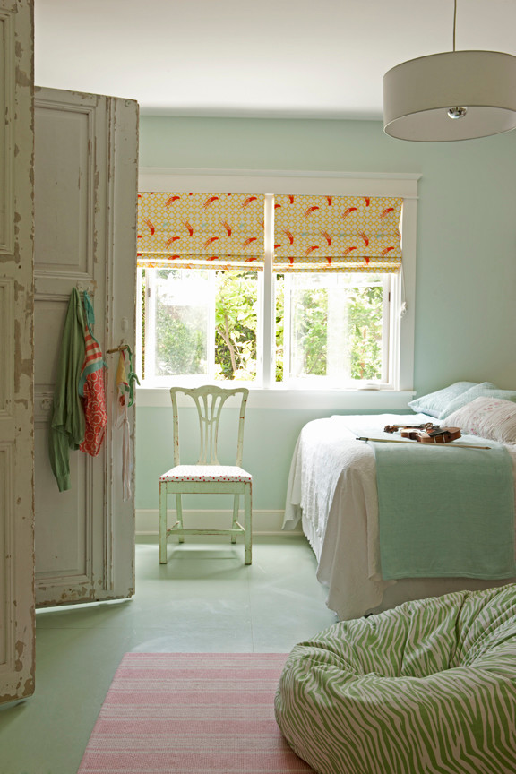 Photo of a mid-sized beach style kids' room for girls in Los Angeles with linoleum floors, blue walls and green floor.