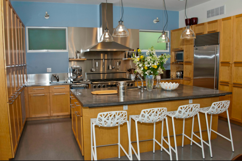 Mid-sized transitional u-shaped concrete floor enclosed kitchen photo in DC Metro with an undermount sink, shaker cabinets, light wood cabinets, concrete countertops, blue backsplash, stainless steel appliances and an island