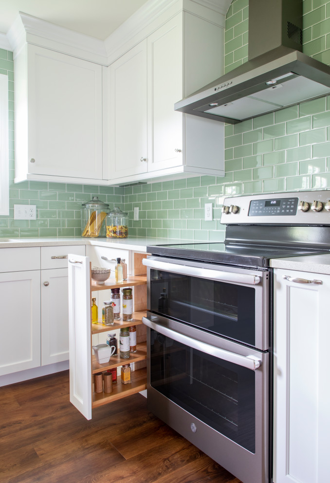 Kitchen - transitional vinyl floor kitchen idea with an undermount sink, shaker cabinets, white cabinets, quartz countertops, green backsplash, glass tile backsplash, stainless steel appliances, no island and white countertops