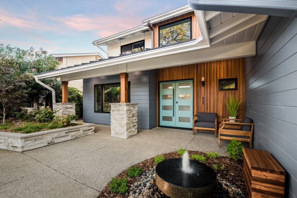 Example of a large trendy blue two-story wood exterior home design in Sacramento with a metal roof and a gray roof