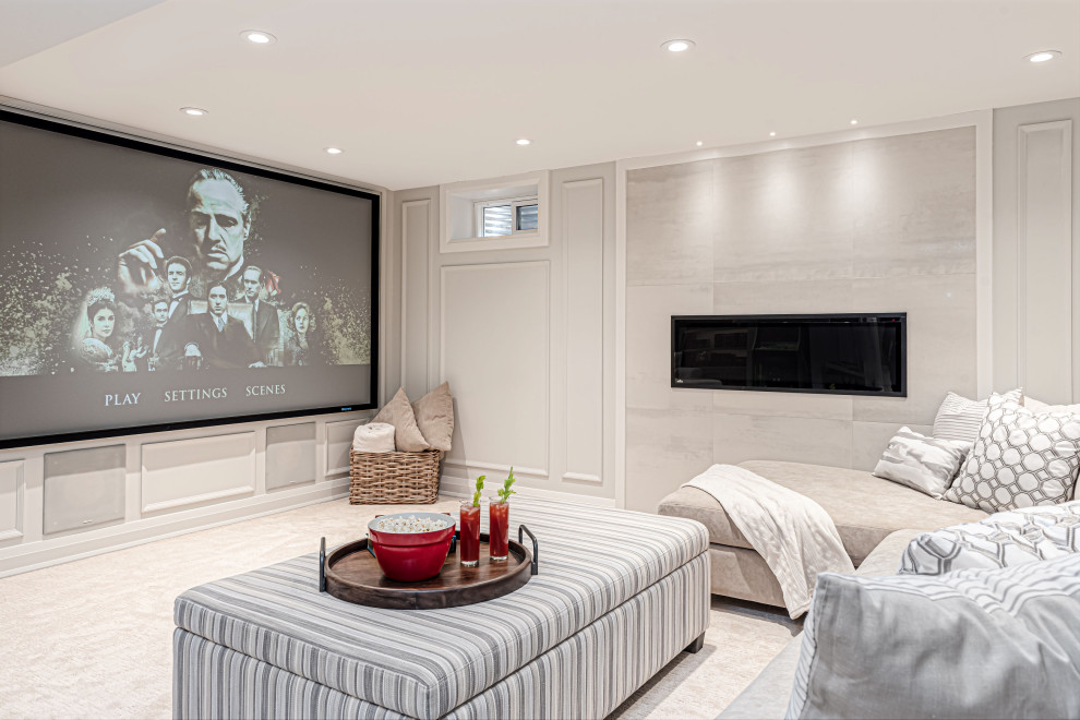 Photo of a medium sized traditional fully buried basement in Toronto with a home cinema, beige walls, vinyl flooring, a tiled fireplace surround and wainscoting.