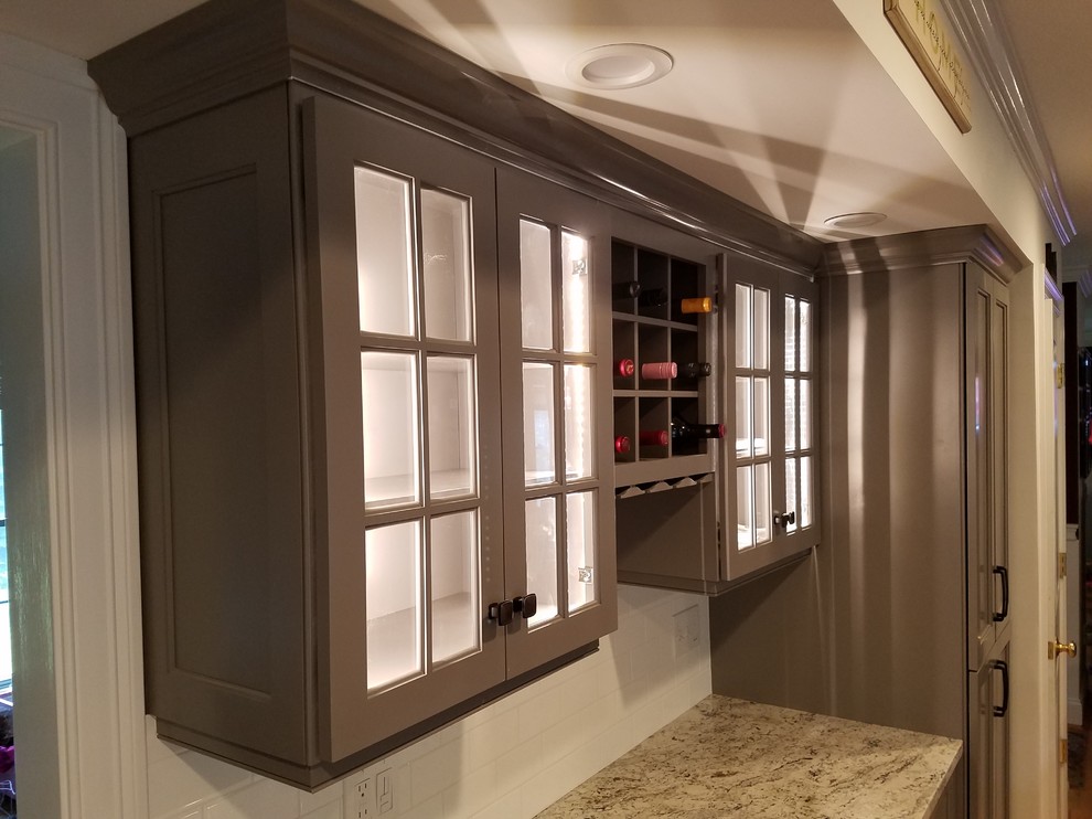 Inspiration for a mid-sized transitional galley light wood floor and brown floor eat-in kitchen remodel with a farmhouse sink, recessed-panel cabinets, gray cabinets, wood countertops, white backsplash, subway tile backsplash, stainless steel appliances and an island