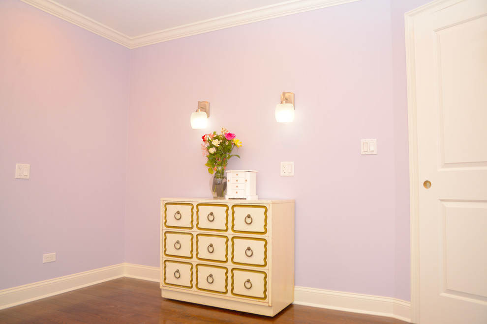 Mid-sized transitional guest bedroom in New York with purple walls, medium hardwood floors and no fireplace.