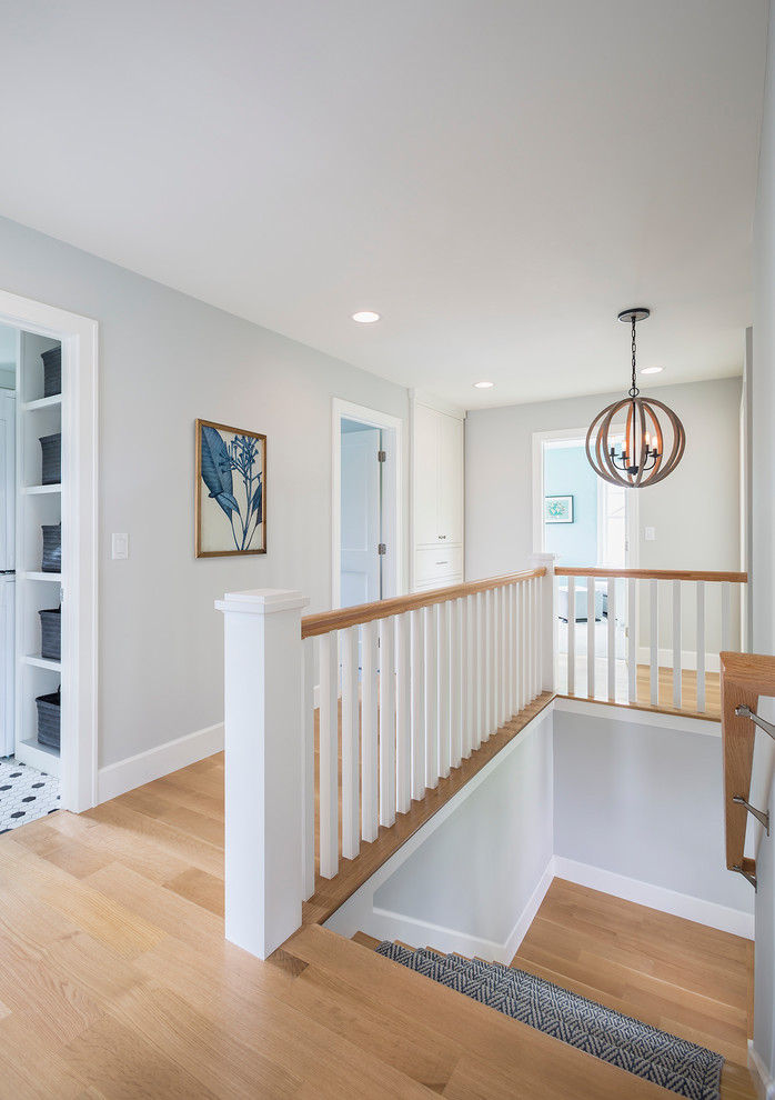 Inspiration for a mid-sized transitional carpeted l-shaped wood railing staircase remodel in Minneapolis with carpeted risers
