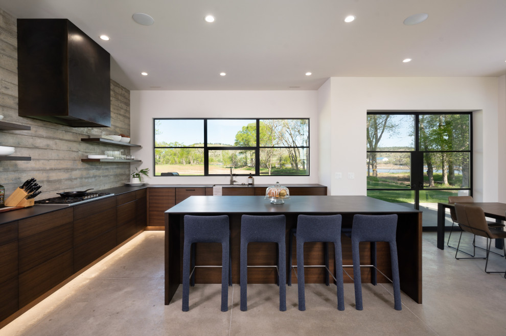 Modern l-shaped open plan kitchen in Other with dark wood cabinets and an island.