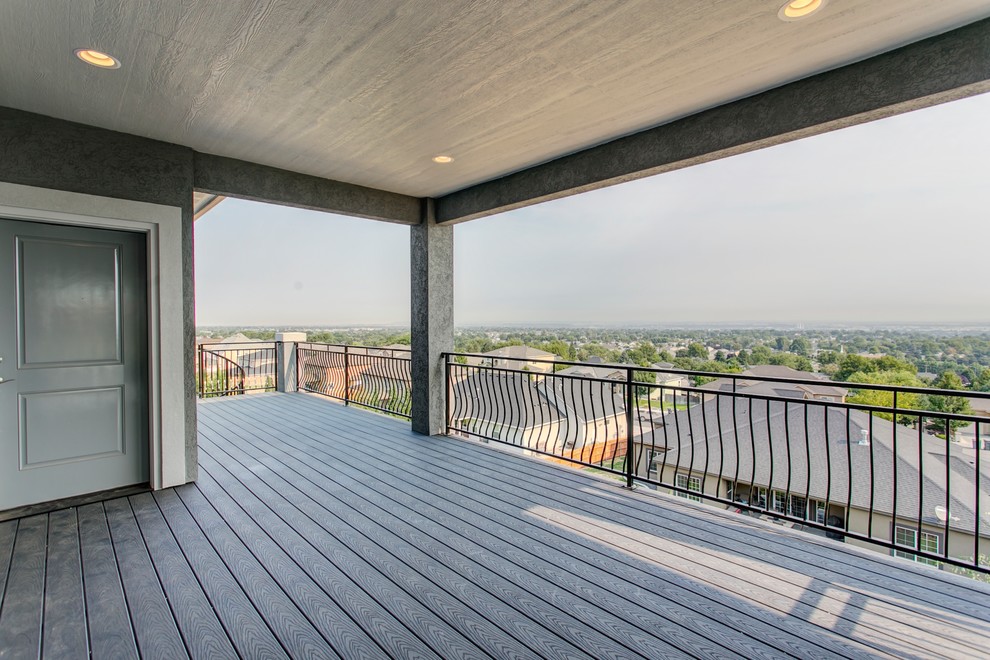 Example of a huge transitional backyard deck design in Seattle with a roof extension