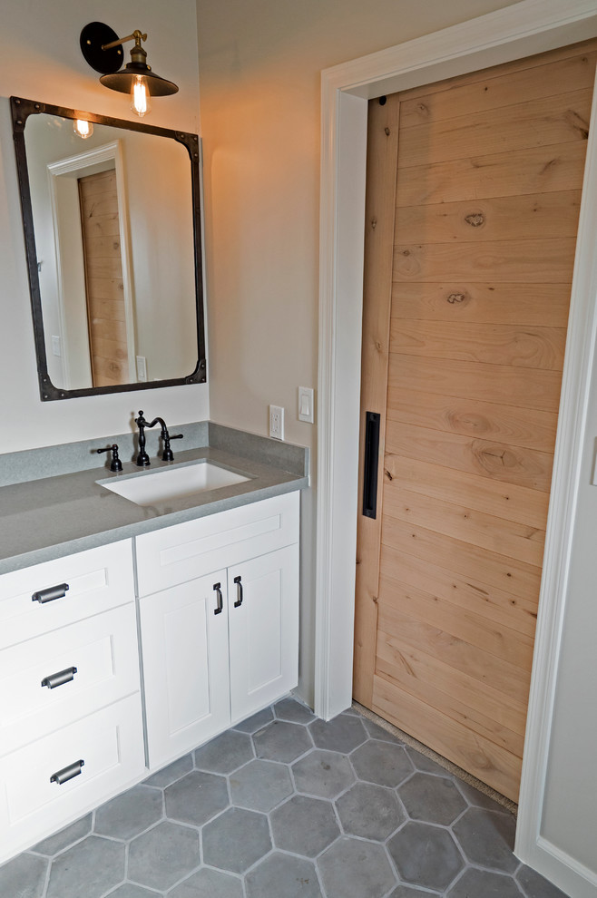 This is an example of a large transitional kids bathroom in Other with an undermount sink, shaker cabinets, white cabinets, engineered quartz benchtops, a drop-in tub, a shower/bathtub combo, a two-piece toilet, gray tile, cement tile, grey walls and concrete floors.
