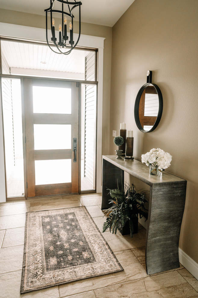 Photo of a mid-sized transitional front door in Cedar Rapids with brown walls, a single front door, a glass front door and beige floor.