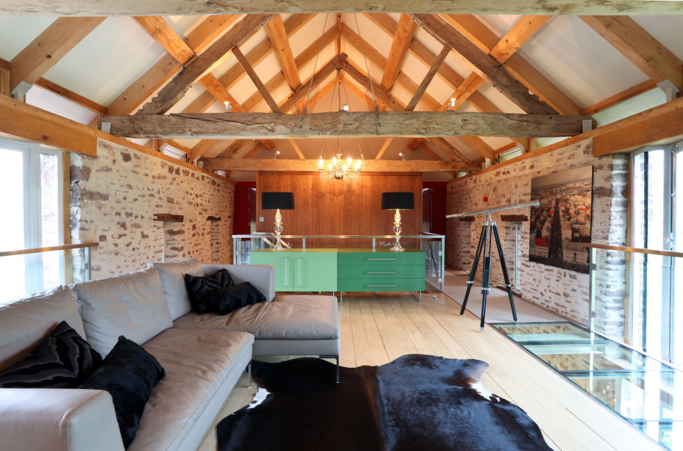 Large contemporary open plan living room in Other with light hardwood flooring.