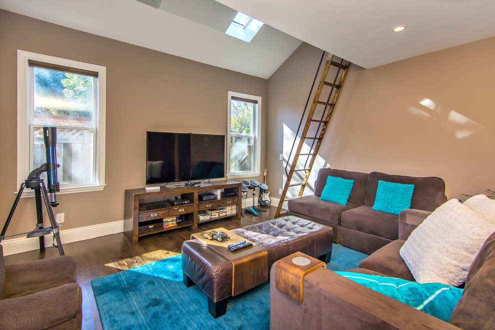 Transitional family room in San Francisco with a game room, beige walls, dark hardwood floors and a freestanding tv.