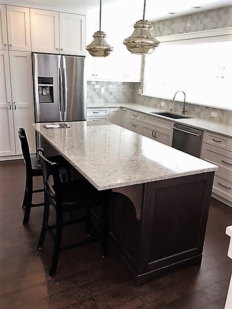 Large transitional dark wood floor and brown floor open concept kitchen photo in Seattle with an undermount sink, shaker cabinets, white cabinets, quartz countertops, multicolored backsplash, glass tile backsplash, stainless steel appliances and an island