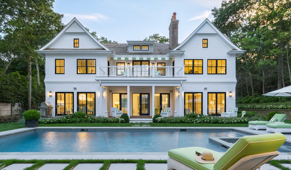 Inspiration for a large traditional three-storey white exterior in New York with wood siding and a gable roof.