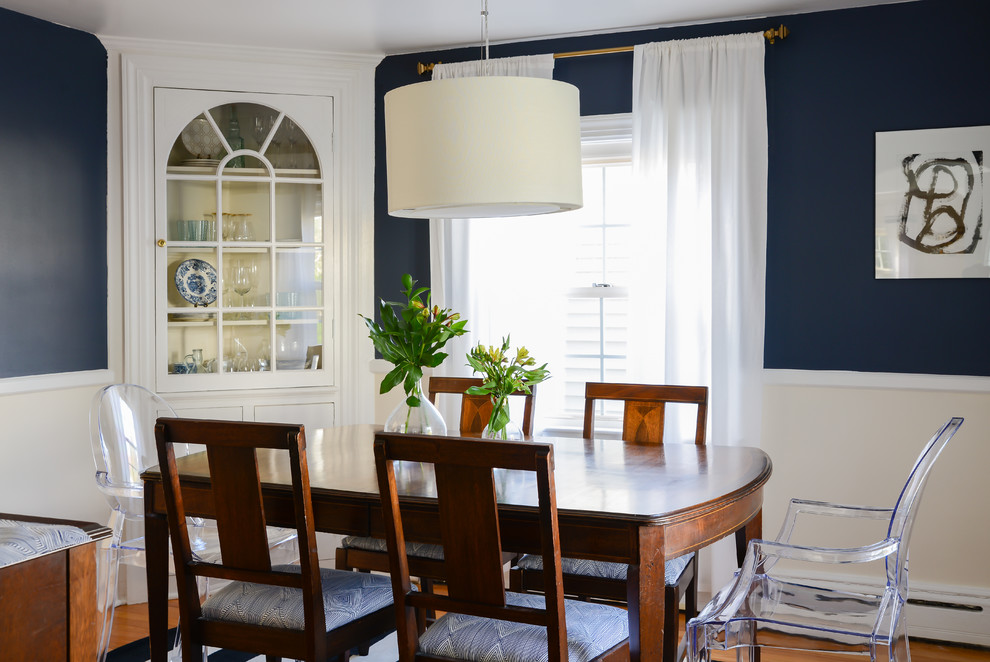 Photo of a traditional dining room in Boston with blue walls and medium hardwood floors.