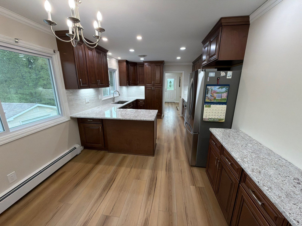 USCD cabinetry accompanied granite countertops, porcelain tile backsplash and Ca