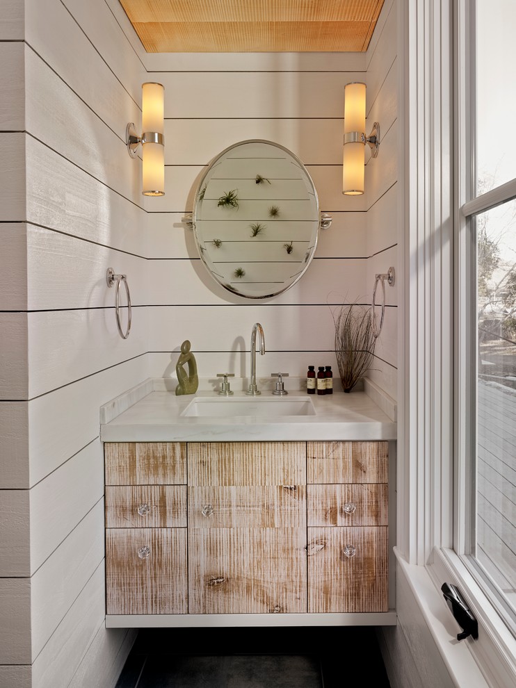This is an example of a country bathroom in San Francisco with an undermount sink, flat-panel cabinets, distressed cabinets and white walls.